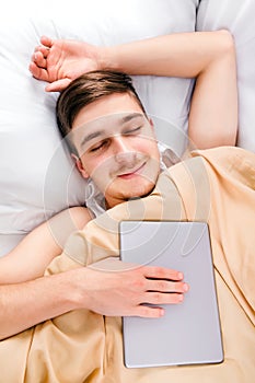 Young Man sleep with a Tablet