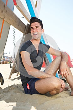 Happy young man smiling at the beach