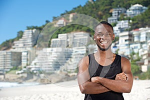 Happy young man smiling at the beach