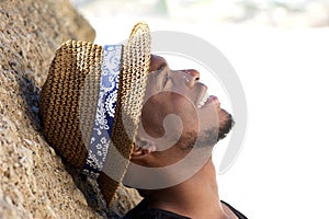 Happy young man smiling with hat