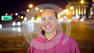 Happy young man smiling to camera in the city. Portrait of a Man Looking at the Camera. Young Ethnic Man Smiles