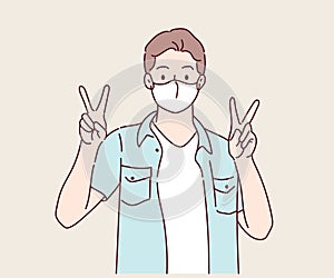 Happy young man with surgical medical mask with victory or confident hand sign gesture