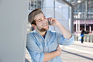 Happy young man talking on mobile phone