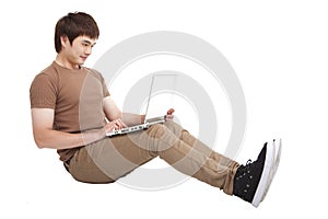 Happy young man using laptop