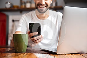 Happy young man using laptop computer