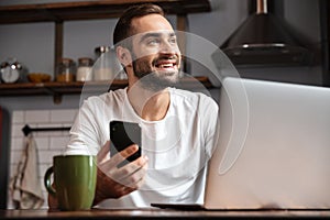 Happy young man using laptop computer