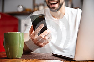 Happy young man using laptop computer