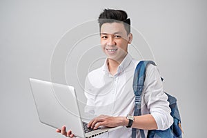 Happy young man using laptop on white background