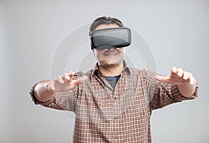 Happy young man using virtual reality headset