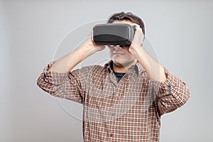 Happy young man using virtual reality headset