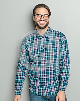 happy young man wearing checkered shirt and glasses and smiling