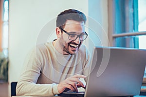 Happy young man, wearing glasses and smiling