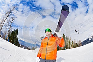 Happy young man wearing mask holds ski in winter