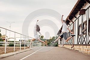 Happy young man and woman jumping and having fun outdoors on a warm summer day. horse rancho