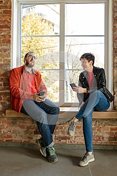 Happy young man and woman sharing in social media