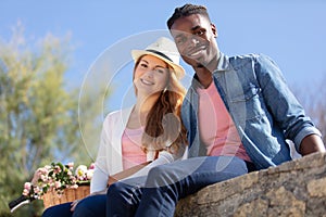 happy young man and woman smiling outdoors