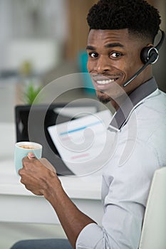 happy young man working in call center