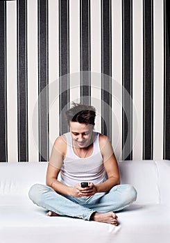 Happy young man writes a message