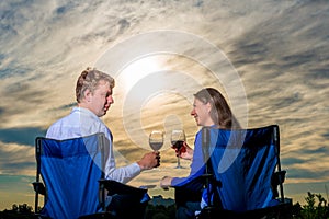 Happy young married couple with a glass of wine