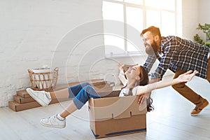 Happy young married couple moves to new apartment