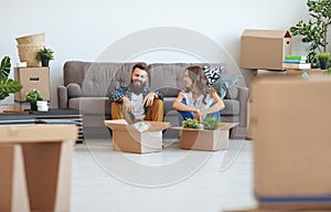 Happy young married couple moves to new apartment