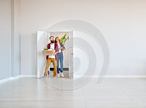 Happy young married couple moves to new apartment