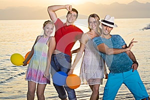 Happy Young Mates at the Beach on Sunset