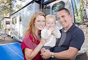 Happy Young Military Family In Front of Their Beautiful RV