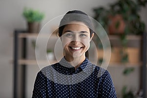 Happy young millennial Indian business woman head shot portrait