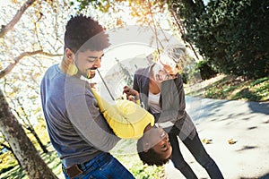 Happy young mixed race couple spending time with their daughter