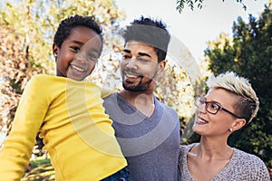 Happy young mixed race couple spending time with their daughter