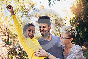 Happy young mixed race couple spending time with their daughter