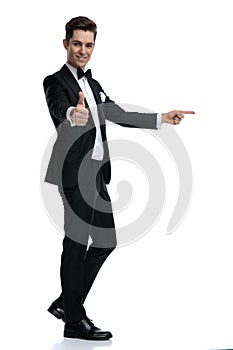 Happy young model smiling and making thumbs up sign