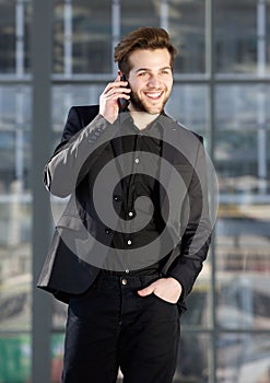 Happy young modern man talking on mobile phone