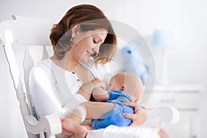 Happy young mother with baby boy at home