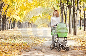 Happy young mother with baby in buggy