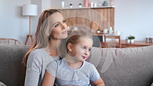 Happy young mother blonde woman hugging daughter girl feeling love tenderness enjoying motherhood