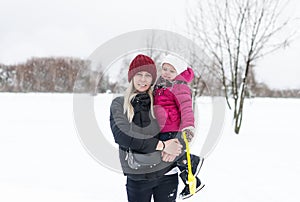 Happy young mother with a child on a winter walk