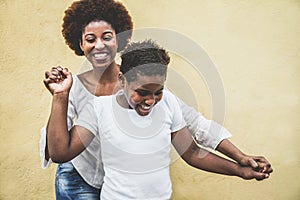 Happy young mother having fun with her child - Mom playing and dancing with his son - Family lifestyle, motherhood, love and