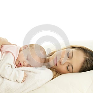 Happy young mother with her sleeping newborn baby