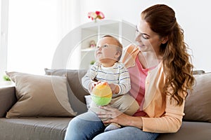 Happy young mother with little baby at home