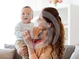 Happy young mother with little baby at home