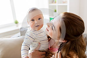 Happy young mother with little baby at home