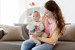 Happy young mother with little baby at home