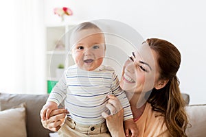 Happy young mother with little baby at home