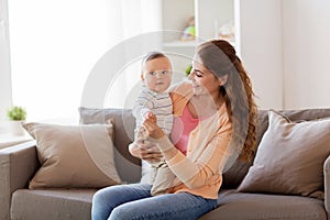 Happy young mother with little baby at home