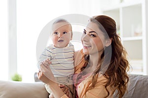 Happy young mother with little baby at home