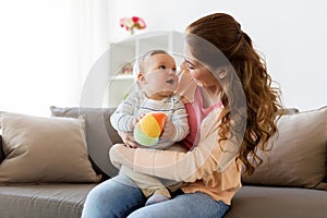 Happy young mother with little baby at home