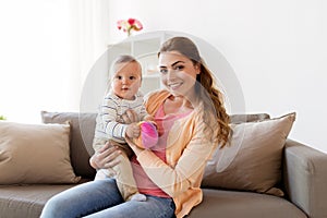 Happy young mother with little baby at home