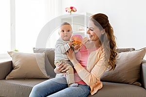 Happy young mother with little baby at home